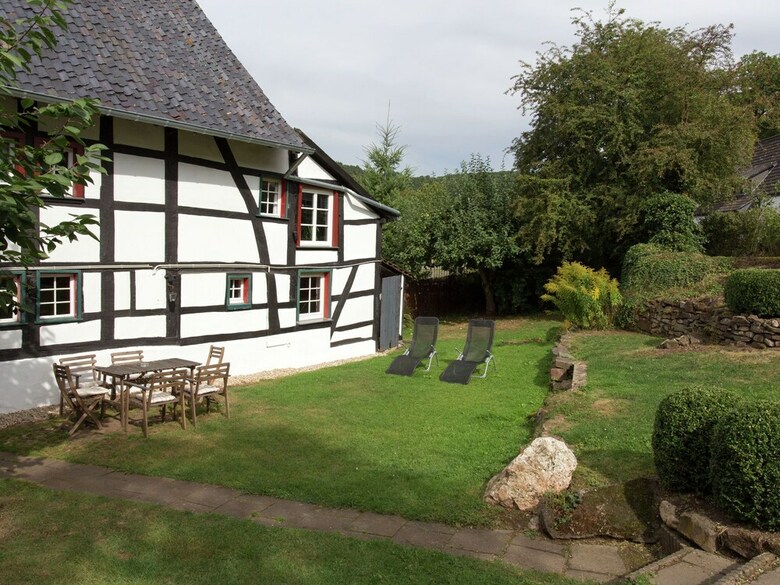 A Lovely Watermill Surrounded By Delightful Greenery