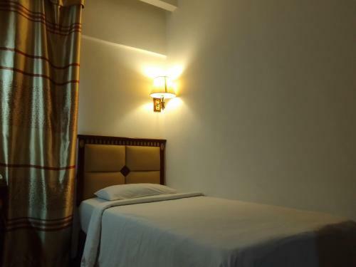 Oyo 90464 Borneo Suites Hotel